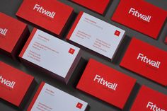 several red business cards with the word fitwall printed on them are arranged in rows