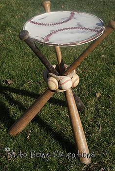 an old baseball and bat stand on the grass