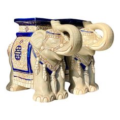 an elephant figurine is painted with blue and white designs on it's trunk