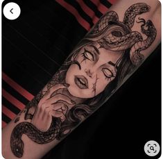 a woman's arm with a snake tattoo on it and her face in the middle