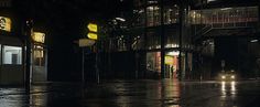 an empty city street at night with rain on the ground