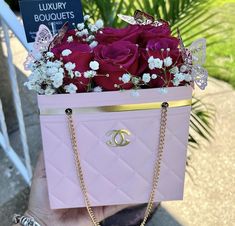 a person holding a pink purse with flowers in it