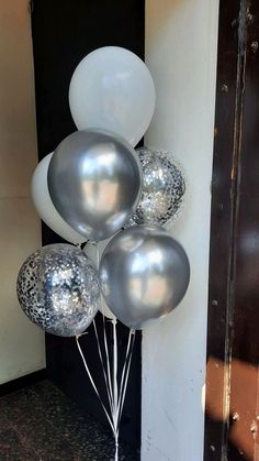 silver and white balloons in front of a door