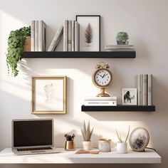 a laptop computer sitting on top of a white desk next to books and other items