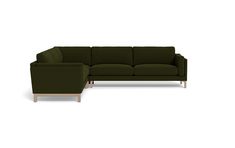 a green sectional couch sitting on top of a white floor next to a wooden frame