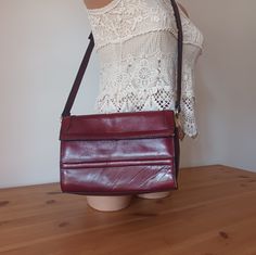 Nice Vintage Women  Burgundy Leather Flap Bag/Cross Body Bag/Shoulder Bag. Retro style. Solid Print. Material: genuine leather. 3 pockets. Burgundy color. Measurements: height: 17.5 cm (6.89") width: 9.5 cm (3.74") length: 25 cm (9.84") Strap length: adjustable. Very good vintage condition with some signs of use. See the photos. Burgundy Leather Handheld Shoulder Bag, Vintage Shopping Shoulder Bag With Mobile Phone Pocket, Handheld Burgundy Shoulder Bag For Travel, Burgundy Handheld Shoulder Bag For Everyday Use, Retro Burgundy Shoulder Bag, Retro Burgundy Shoulder Bag For Daily Use, Retro Burgundy Shoulder Bag For Everyday, Burgundy Rectangular Shoulder Bag With Adjustable Strap, Rectangular Burgundy Shoulder Bag With Adjustable Strap