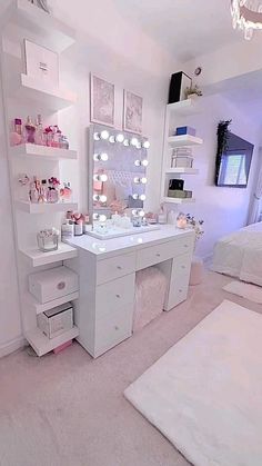 a white vanity with lights on it in a bedroom next to a bed and rug