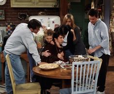 friends gathered around a table in the kitchen