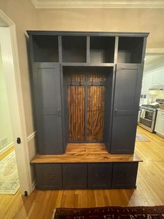 an empty living room with built in bookshelves and cupboards on the floor