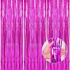 pink tinsel foil curtain with hand holding it