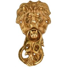 a golden lion head door knocket on a white background