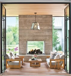 a living room filled with furniture and a fire place in front of a wall mounted fireplace