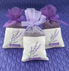 three bags filled with lavender tea sitting on top of a purple blanket