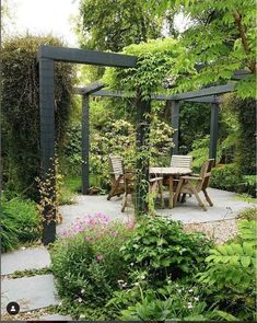 an outdoor dining area in the middle of a garden