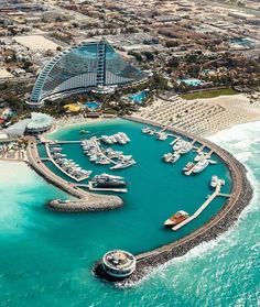 an aerial view of a marina with boats and hotels in the background