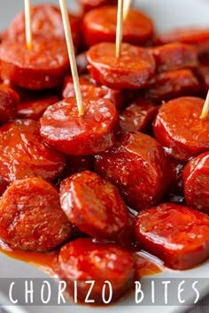 hotdogs with ketchup and toothpicks on a white plate