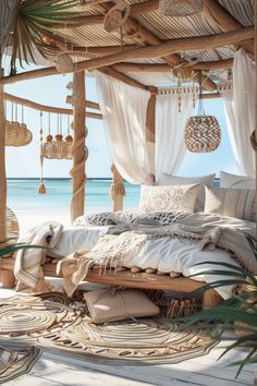 a bed sitting on top of a wooden floor next to the ocean with lots of pillows