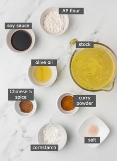 the ingredients to make this recipe are shown in small bowls on a marble countertop