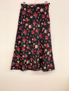 Vintage black floral skirt Approximate Size: 13 W; 33 L Black Floral Print Maxi Skirt For Spring, Black Floral Print Skirt, Summer Black Maxi Skirt With Floral Print, Fall Floral Print Flared Maxi Skirt, Floral Print Flared Maxi Skirt For Fall, Fall Floral Print Flared Skirt, Floral Print Flared Skirt For Fall, Chic Black Floral Print Maxi Skirt, Black Skirted Bottoms With Floral Print