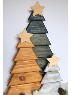 This set of custom trees are perfect for the winter season. Their compact size and flat profile make them ideal for smaller spaces and homes. Great as a Christmas centerpiece, shelf sitter, fireplace mantle or even bar top. They make a great gift for family friends, first time homeowners and neighbors. Their neutral color can blend into any style. You can choose from different color pallets or create your own. Made from 100% recycled pallet wood Small Tree: 9" x 2.75" x 12" Medium Tree: 13" x 2.75" x 18" Medium Tree: 17" x 2.75" x 25.5" As the wood pattern and grains vary from wood type there will be variations in the colors when stained. There also might be wood knots, uneven texture and filled holes from where there were nails.  **Due to each piece being made to order, we do not offer re Christmas Trees Made Out Of Pallets, Homemade Centerpieces, Scandinavian Christmas Decor, Pallet Tree, Friends First, Wood Art Diy, Tree Shelf, Scandinavian Christmas Decorations