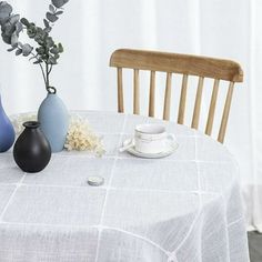 three vases sitting on top of a white table