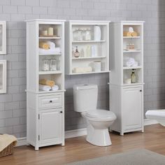 a white toilet sitting next to a bathroom cabinet