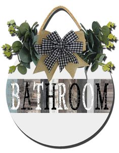 a sign that says bathroom with a bow and flowers in the center, on a white background