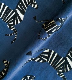 a blue fabric with zebras on it