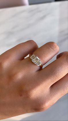 a woman's hand with a diamond ring on it