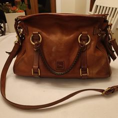 This Gently Used Leather Satchel Is Made From Italian Vacchetta Leather, Which Grows Softer With Age. It Adds A Chic Touch That Pulls Together Any Outfit. -It Is Made Of Supple Italian Florentine Leather With A Zipper Closure. -Adjustable, Detachable Shoulder Strap. The Strap Drop Length Is 19" -Handle Drop Length Is 4.5" -H8" X W 5.75" X L 13" -Weights 2 Lbs, 10 Oz. Currently Retails For $538 At Https://Www.Dooney.Com/Florentine-Satchel-8l980.Html?Cgid=Best-Sellers Womens Handbags, Womens Purses, Purse Bag, Leather Satchel, Dooney Bourke, Color Orange, Best Sellers, Satchel, Women Handbags