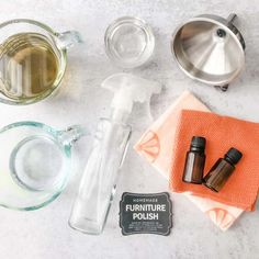 the ingredients to make homemade furniture polish laid out on top of a marble countertop