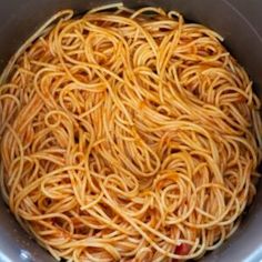 the noodles are being cooked in the pot