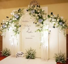 an arch decorated with flowers and greenery for a wedding or reception ceremony at the same time