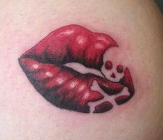 a woman's stomach with a skull and red lipstick on it