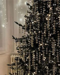 a black christmas tree decorated with silver ornaments