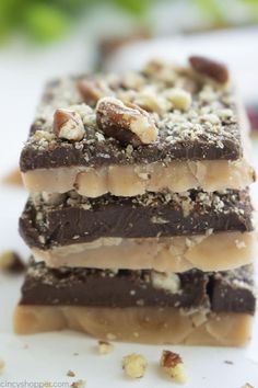 three pieces of chocolate and nuts on top of each other