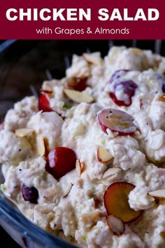 a close up of a bowl of food with grapes and almonds on the side