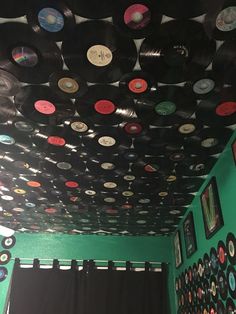 a room filled with lots of records on the ceiling