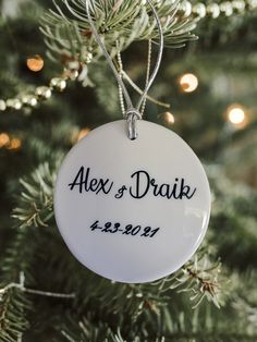 a personalized ornament hanging from a christmas tree