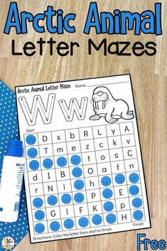 an arctic animal letter maze is shown next to a blue polka dot tie on a wooden surface