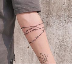 a person with barbed wire on their arm