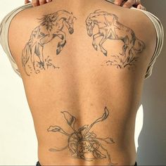 the back of a woman's body with tattoos on it