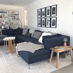 a living room filled with lots of furniture and pictures on the wall above it's couch