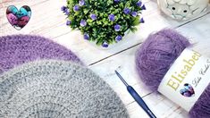 purple and grey yarn next to a potted plant