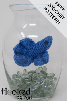 a crocheted blue fish in a glass jar