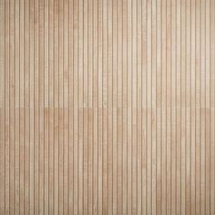 a wooden wall with vertical lines painted on the wood paneling in light brown tones