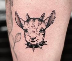 a goat with horns and spikes on its head is shown in this tattoo style photo