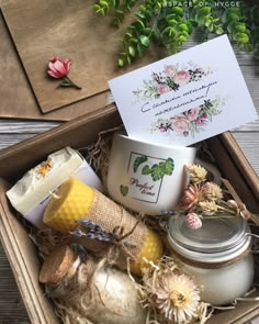 an open box filled with different types of soaps and body scrubs on top of a wooden table