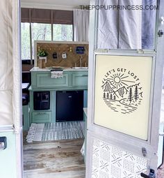 an rv kitchen is seen through the door