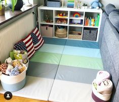 a child's playroom with toys and bookshelves in the corner,